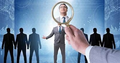 Magnifying glass over digital search icons, symbolizing talent search
