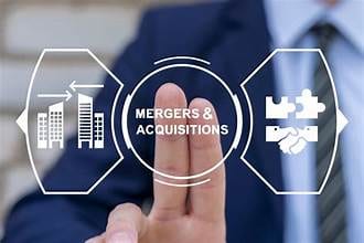 Business person pointing at a mergers and acquisitions icon diagram