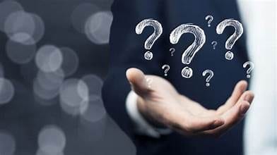 A hand raised beneath floating question marks